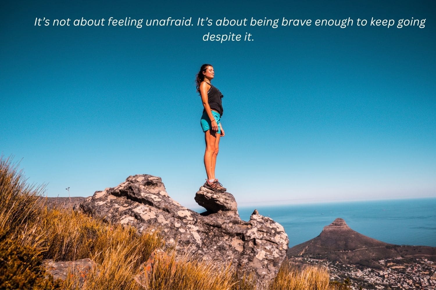 woman standing on a rock, standing straight and looking forward her future